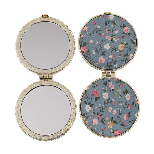 Compact purse mirror with magnifying and standard sides, folding metal design